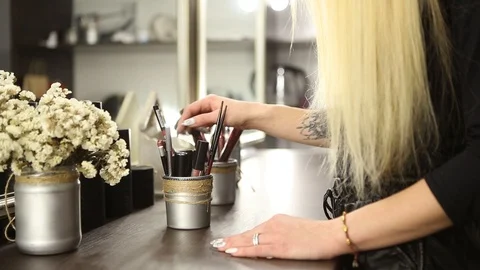 Make-up artist selects of the brush picks for applying makeup Stock Footage 99932555