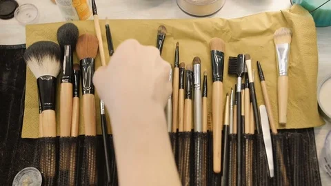 Make-up artist taking brushes from professional brush set. Beauty, makeup and Stock Footage 74459960