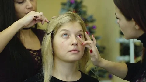 Make-up artist work on her friend. Real people Stock Footage 73797946