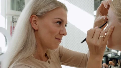 Make-up artist work on her friend. Real blonde people. Video stock 146683435