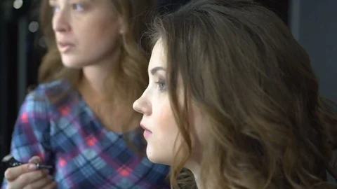 Make-up artist work on her friend.Real people Stock Footage 82274375