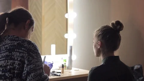 Make-up artist work with model preparing photoshoot Stock Footage 72600700