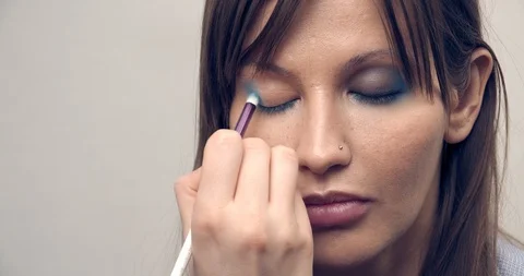 Make-up Artist at work.Eye make-up. Make-up artist putting on make-up on model's Stock Footage 126356599