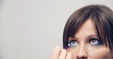 Make-up Artist at work.Eye make-up. Make-up artist putting on make-up on model's Stock Footage 126356631
