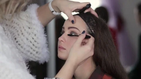 Make-up artist working with model Video stock 72028287