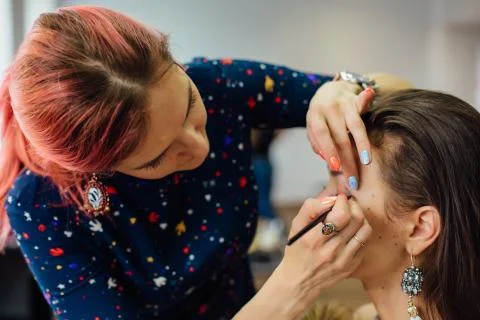 Make-up artist working in studio. Stock Photos