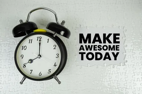 Make Awesome Today text with alarm clock on white background Stock Photos