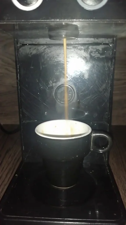 Make a black coffee with the capsule machine Stock Footage 129706595