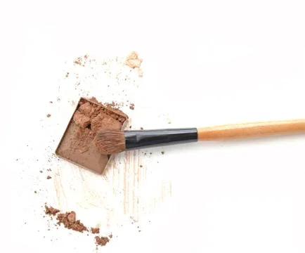Make up brown eye shadow on white with brush. Stock Photos