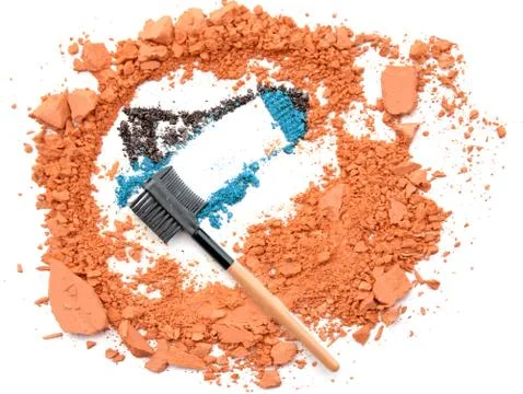 Make up brush blue eye shadow on orange powder Stock Photos