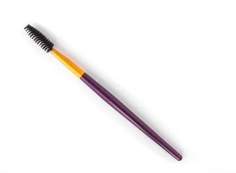 Make-up brush for combing eyebrows, close-up, white background, cosmetic brush Photos