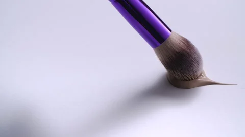 Make up brush draws a swatch of brown foundation. 4K. Stock Footage 166550421