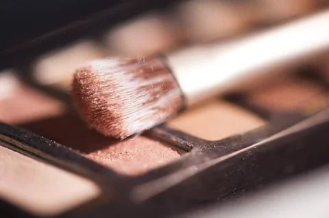 Make up brush on eye shadow palette closeup. Selective focus. Stock Photos