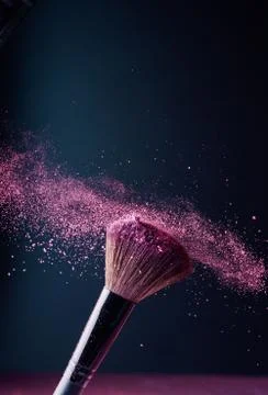 Make-up brush with p powder explosion Stock Photos