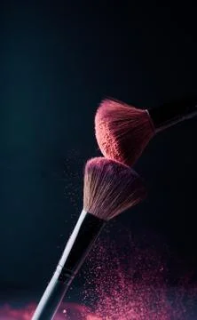 Make-up brush with p powder explosion Stock Photos