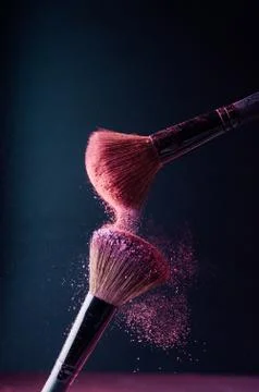 Make-up brush with p powder explosion Stock Photos