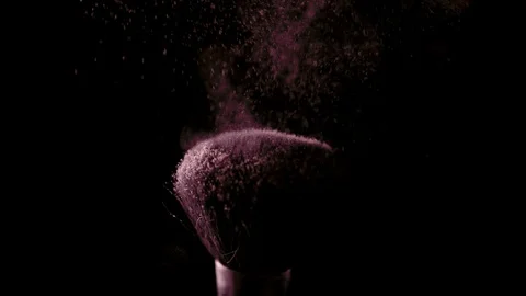 Make-up brush with pink powder on black background slow motion Stock Footage 123154650
