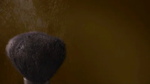 Make-up brush with powder on a gold background Stock Footage 123154649