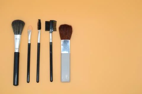 Make up brush set flat lay on peach Background Stock Photos