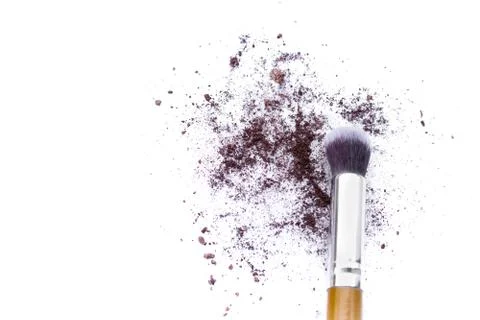Make up brushes and brown eye shadows on black background. Stock Photos