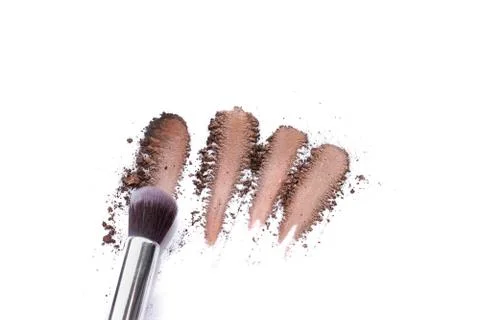 Make up brushes and brown eye shadows on black background. Foto stock