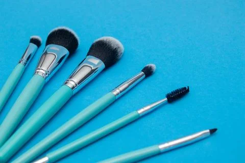 Make up brushes on blue background Stock Photos