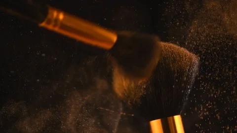 Make-up brushes with gold powder explosion on black background. Creative makeup 스톡 동영상 125894426