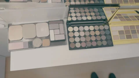 Make-up brushes laying on colorful cosmetic palette. Camera rotation Stock-Footage 90601050