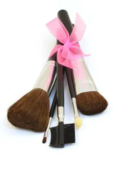 Make-up brushes with pink bow isolated over white 스톡 사진