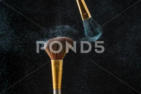 Make-up brushes with powder isolated on black background Stock Photos