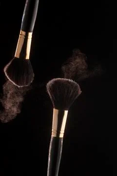 Make up brushes with powder splashes explosion Stock Photos