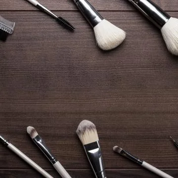 Make-up brushes on wooden background Stock Photos