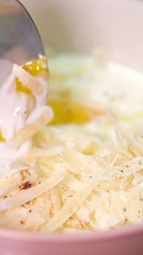 Make carbonara pasta sauce eggs cream parmesan mix in a bowl Stock Footage 301315060