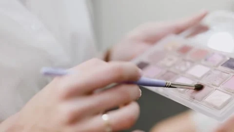 Make-up concept. Makeup artist hand with brush applying makeup. Close-up Stock-Footage 312255959