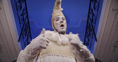 A make-up cool dramatic funny mime guy on a blue theatrical stage shows thumbs Stock Footage 177570114