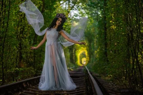 Make up of dead bride dressed in wedding clothes in the tunnel inside a forest Stock Photos