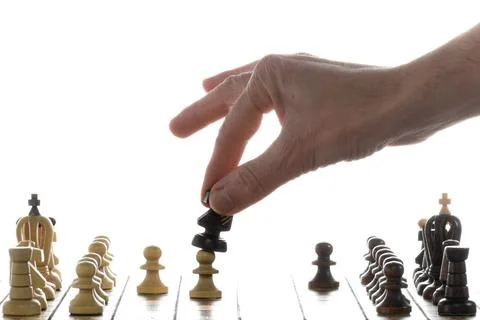 Make decisions and challenge. Chess player makes a move. Stock Photos