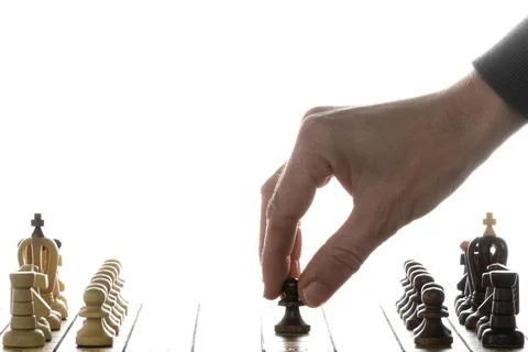 Make decisions and challenge. Chess player makes a move. Stock Photos