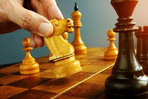 Make decisions and challenge concept. Chess player makes a move. Stock Photos