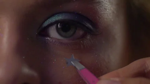 Make-up is decorated with a sticker under the eye. Stock Footage 77604281