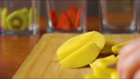 To make dessert, the mango is peeled and chopped Stock Footage 246439474