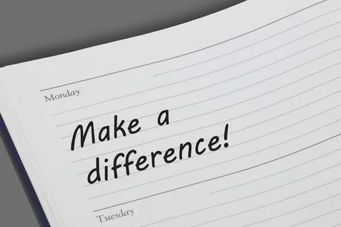 Make a difference concept diary reminder open on a desk Illustrazione stock
