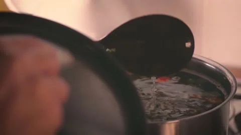 Make dinner. Minestrone soup boiling in the pot, woman cooking vegetarian health Stock Footage 143554842