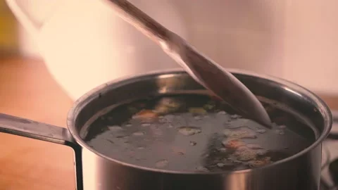Make dinner. Minestrone soup boiling in the pot, woman cooking vegetarian health Stock Footage 143556474