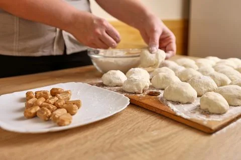 To make donuts, toffee is added to the dough. The process of making donuts Stock Photos