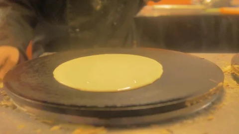 Make flour, egg and butter crepes on a plate with a lot of smoke Stock Footage 124496095