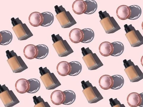Make up foundation bottle and application egg pattern on pink Stock Photos