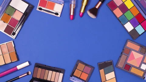 Make up frame move on dark blue background with copy space. Stop motion flat lay Stock Footage 153175501