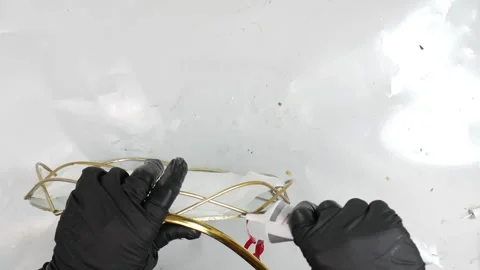 Make a gold craft tray with black gloves. Top view and white table. Craft foo Stock Footage 146238324