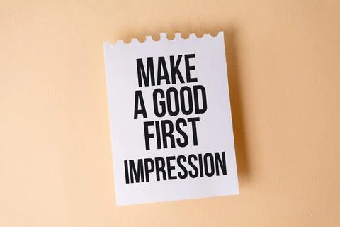Make a Good First Impression text on white sticky note on yellow background. Foto stock